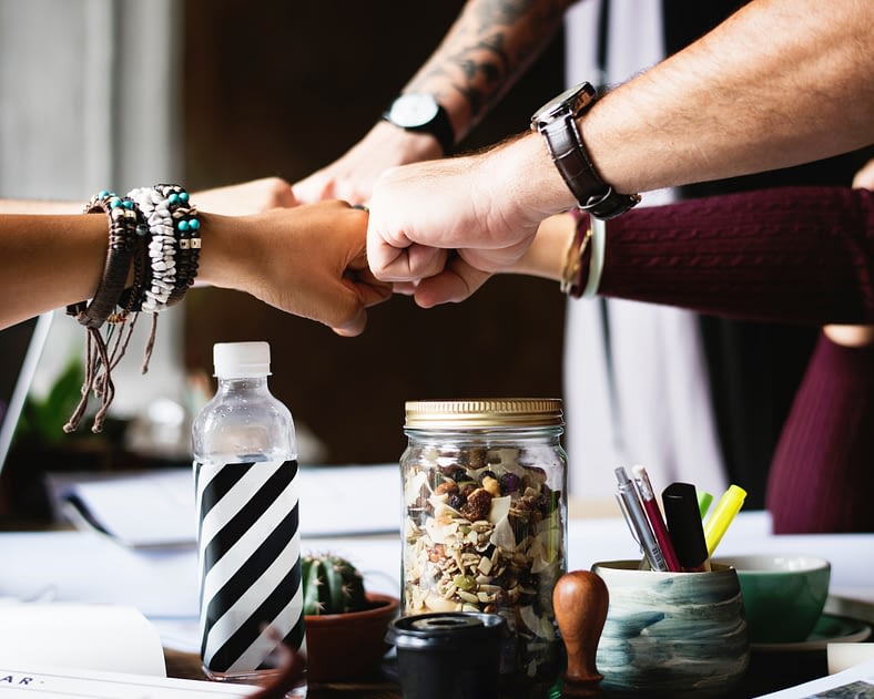 negative-space-office-team-building-fist-bump-desk-rawpixel
